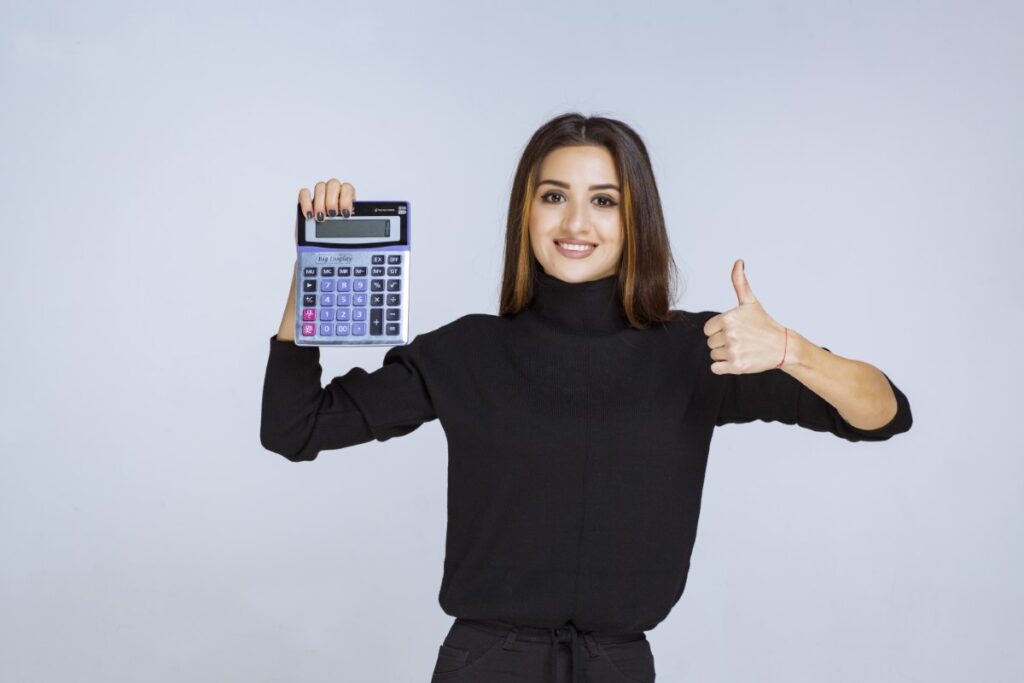 woman showing a thumbs up when calculating her notary profits. notary marketing ideas to save money
