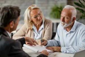 older couple meeting with a bank manager discussing the power of attorney